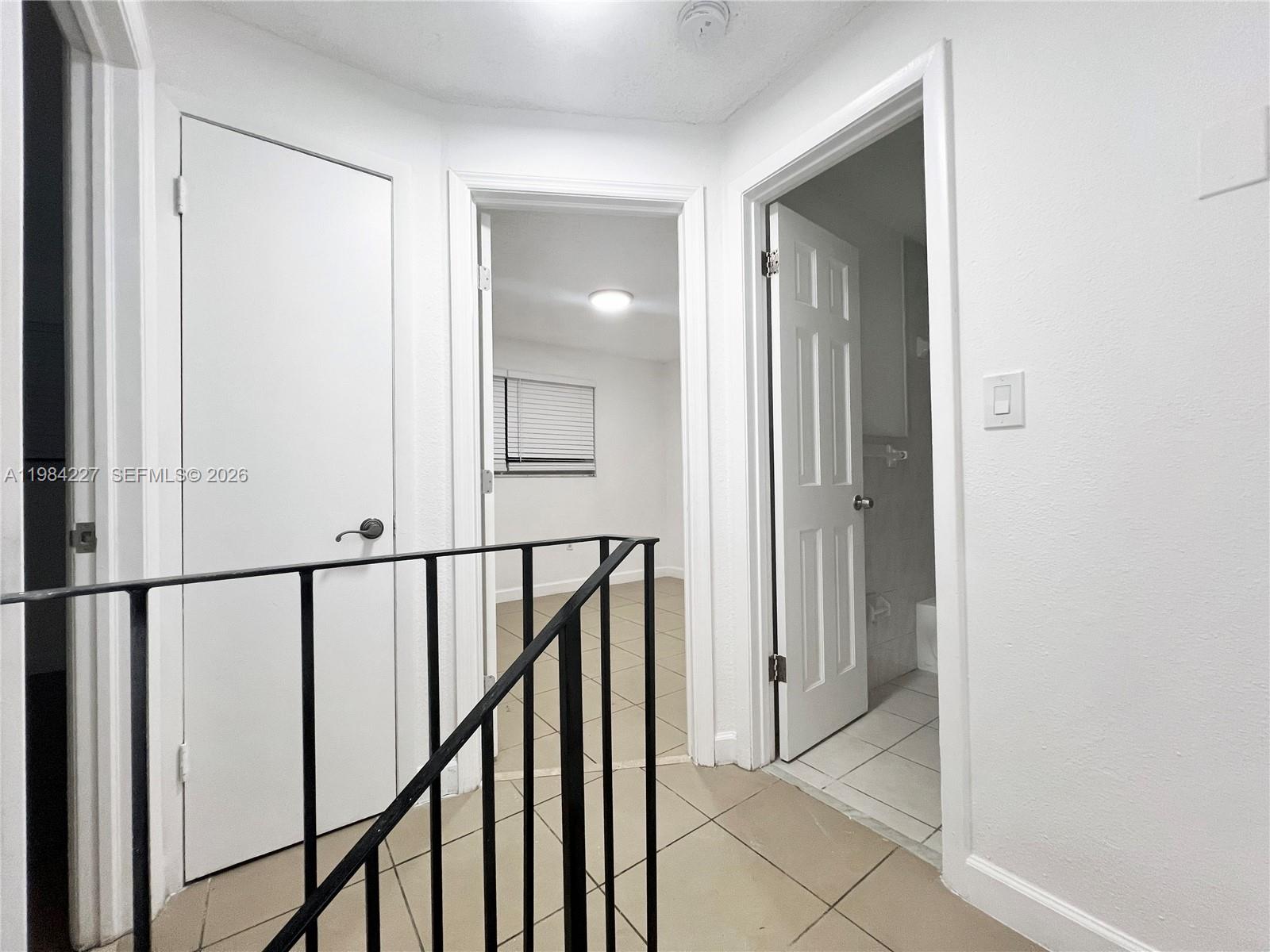 65 Northeast 59th Street, Unit 2 Miami, FL 33137 - Photo 7 of 14 a view of a hallway with wooden floor and staircase