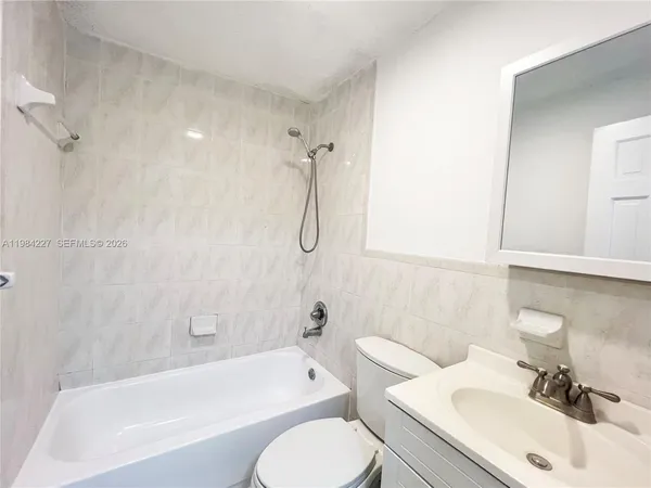 a bathroom with a sink toilet and bathtub