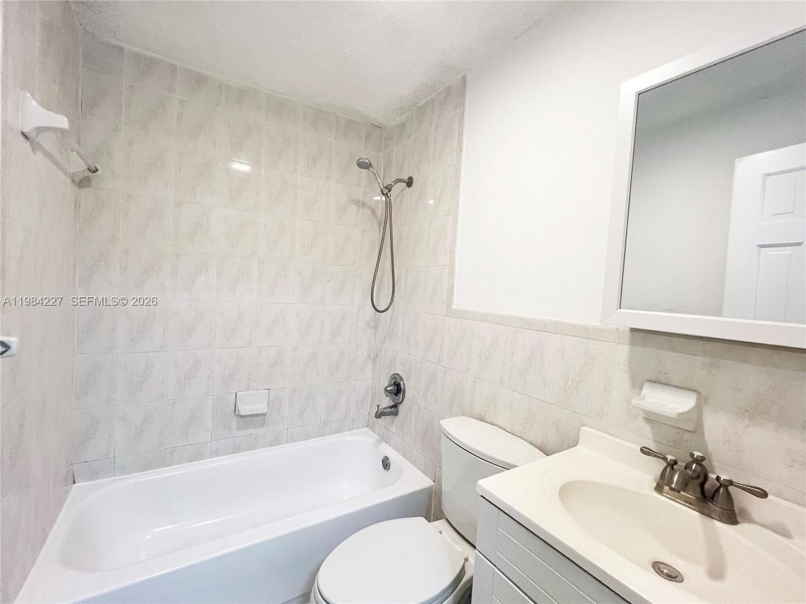 65 Northeast 59th Street, Unit 2 Miami, FL 33137 - Photo 9 of 14 a bathroom with a sink toilet and bathtub