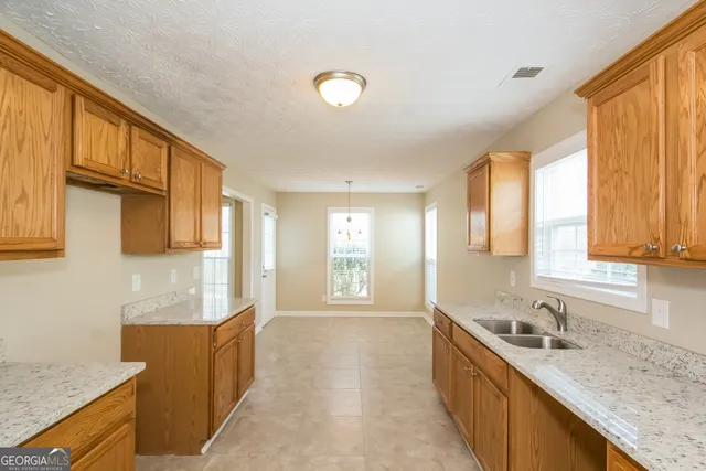 a large kitchen with stainless steel appliances granite countertop a sink and dishwasher next to a window