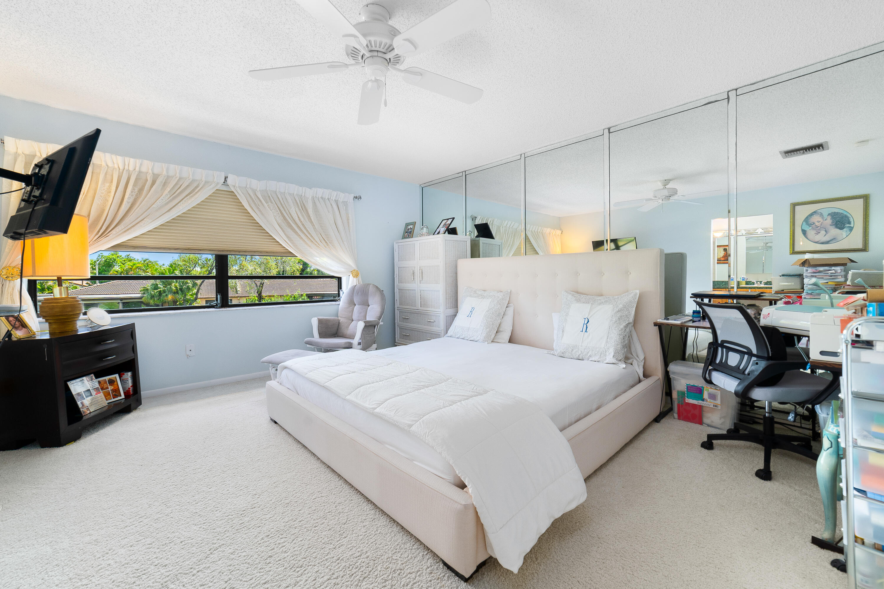 21160 Juego Circle, Unit 13C Boca Raton, FL 33433 - Photo 15 of 41 a bedroom with a bed and a chandelier