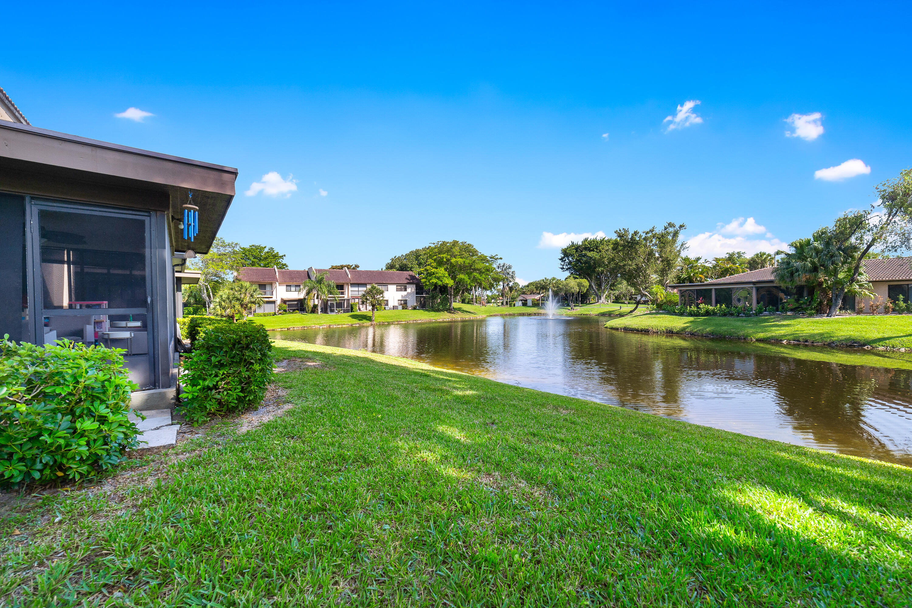 21160 Juego Circle, Unit 13C Boca Raton, FL 33433 - Photo 27 of 41 a view of a lake with a building in the background