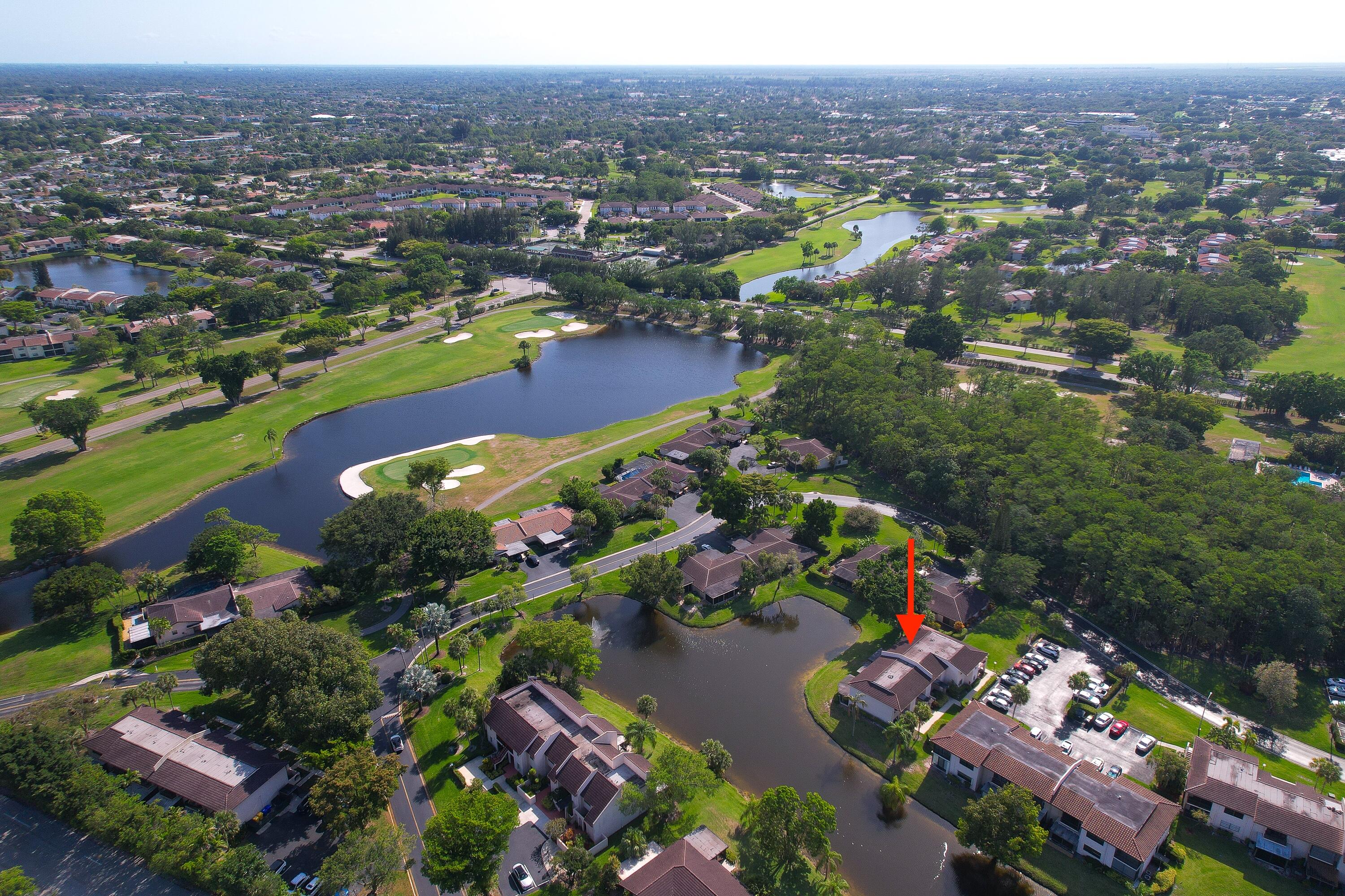 21160 Juego Circle, Unit 13C Boca Raton, FL 33433 - Photo 34 of 41 an aerial view of lake and residential houses with outdoor space