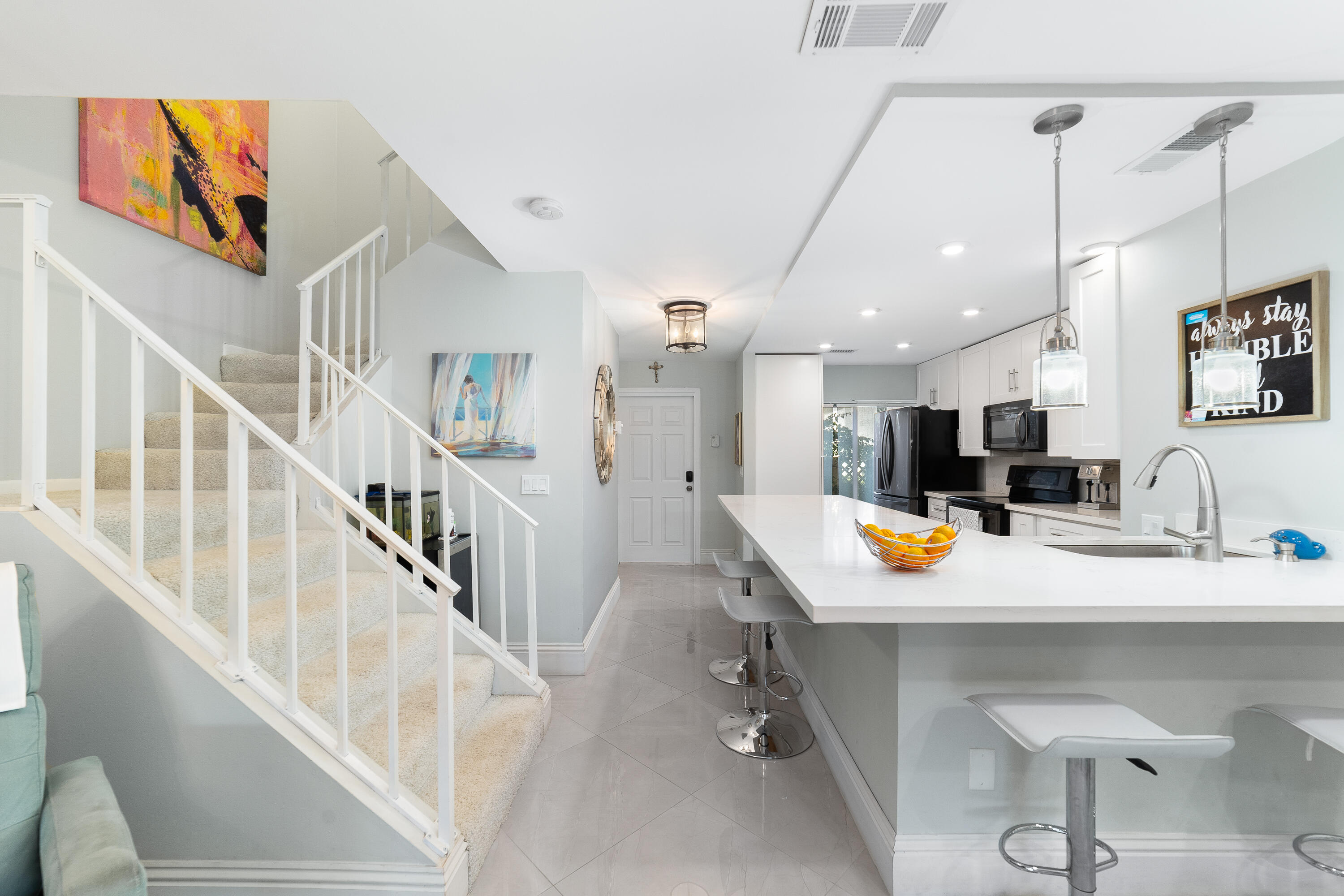 21160 Juego Circle, Unit 13C Boca Raton, FL 33433 - Photo 9 of 41 a view of kitchen and dining area with furniture