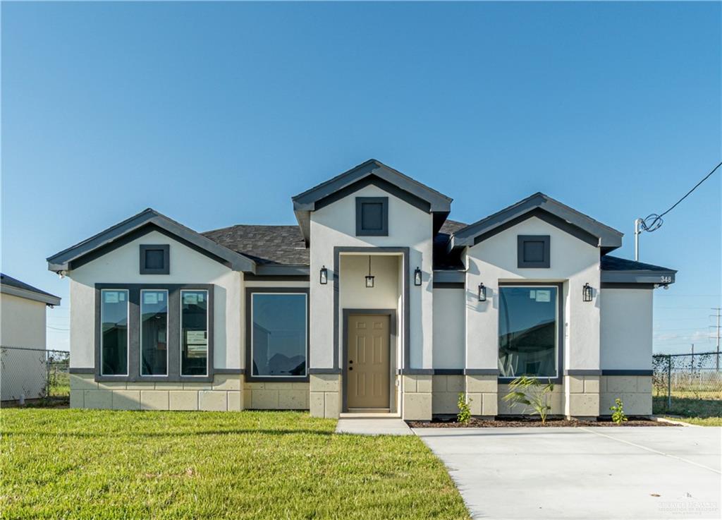 348 Merida Street Donna, TX 78537 - Photo 1 of 19 a front view of a house with a yard