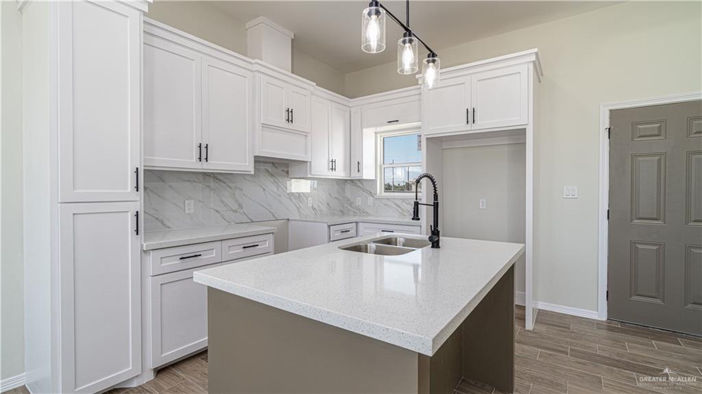 348 Merida Street Donna, TX 78537 - Photo 3 of 19 a kitchen with a sink a stove a refrigerator and cabinets