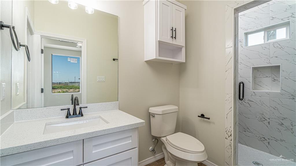 348 Merida Street Donna, TX 78537 - Photo 9 of 19 a bathroom with a sink a toilet and shower