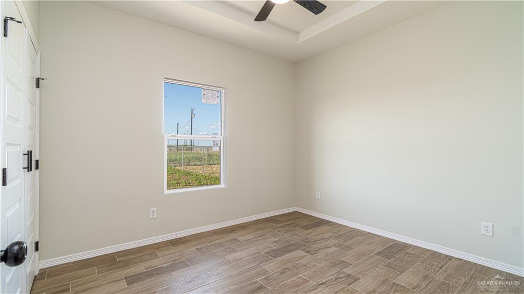 348 Merida Street Donna, TX 78537 - Photo 10 of 19 an empty room with wooden floor and windows