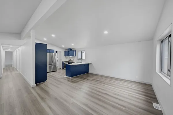 a view of an empty room and a window