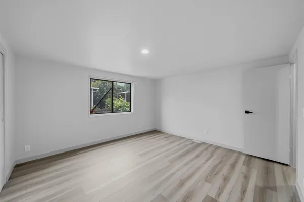 a bedroom with a large bed and a window
