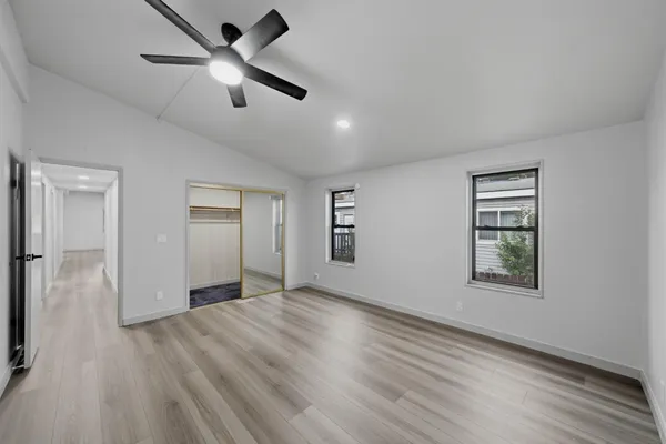 a view of empty room with wooden floor