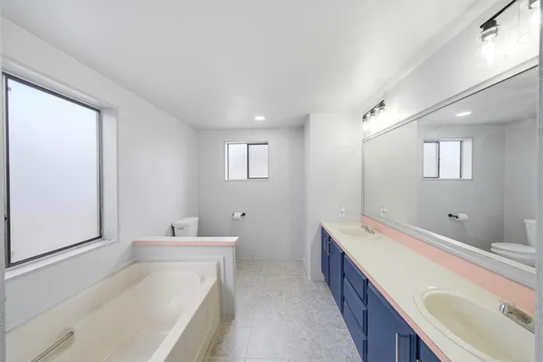 a spacious bathroom with a double vanity sink mirror and