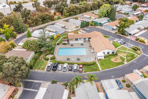an aerial view of a house with garden space and street view