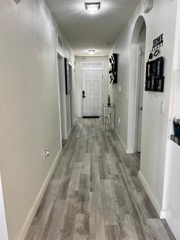 1404 Tawny Ridge Road Kissimmee, FL 34744 - Photo 12 of 21 a view of a hallway with wooden floor