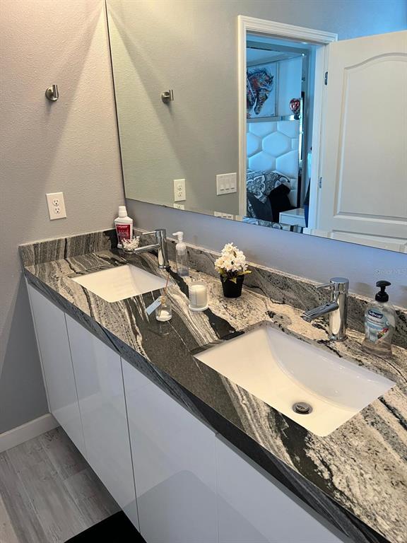 1404 Tawny Ridge Road Kissimmee, FL 34744 - Photo 13 of 21 a bathroom with a sink and a mirror