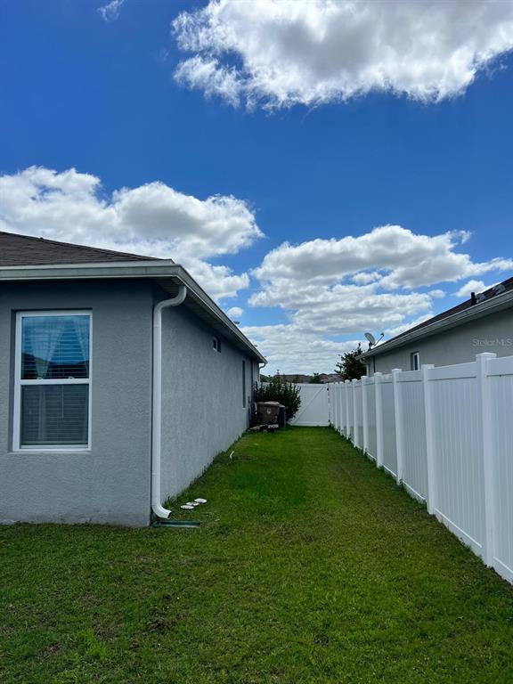 1404 Tawny Ridge Road Kissimmee, FL 34744 - Photo 19 of 21 a backyard of a house with lots of green space