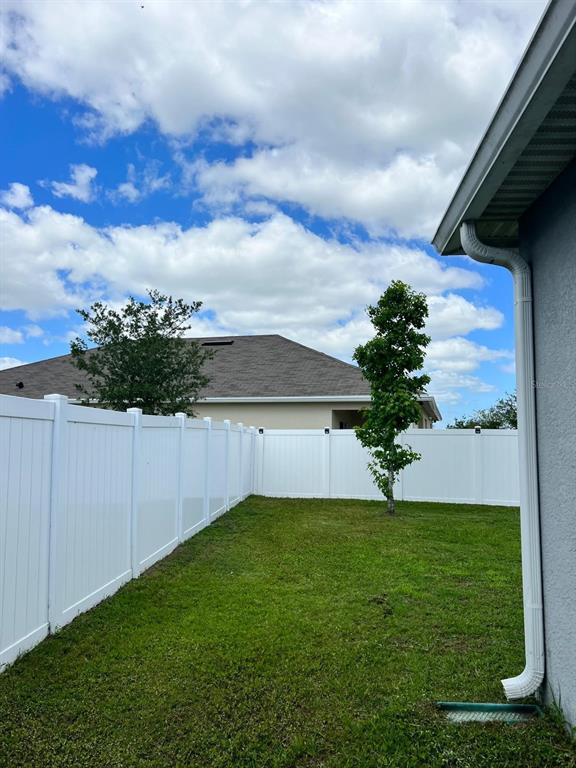 1404 Tawny Ridge Road Kissimmee, FL 34744 - Photo 20 of 21 a view of a backyard with a garden