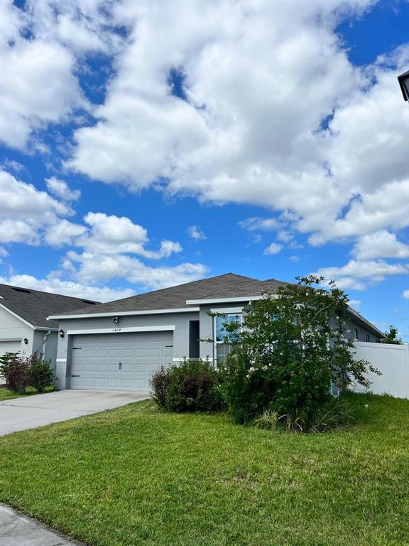 1404 Tawny Ridge Road Kissimmee, FL 34744 - Photo 2 of 21 a view of a yard in front of a house