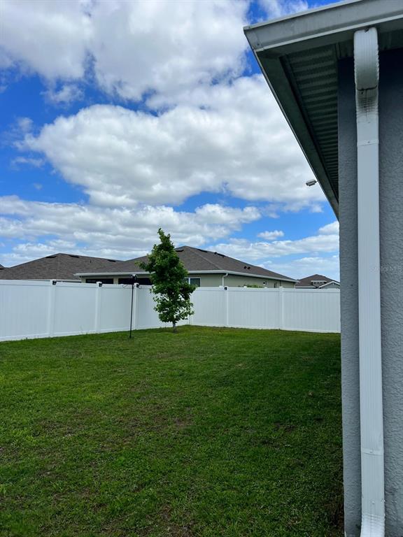 1404 Tawny Ridge Road Kissimmee, FL 34744 - Photo 21 of 21 a view of a backyard with plants and a bench