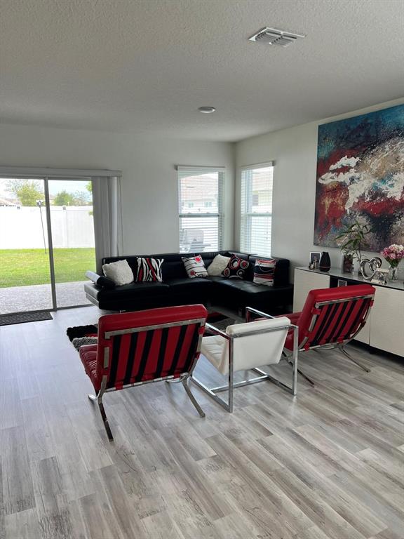 1404 Tawny Ridge Road Kissimmee, FL 34744 - Photo 7 of 21 a living room with furniture and a large window