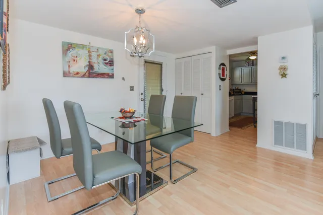 a living room with furniture a flat screen tv and a large window