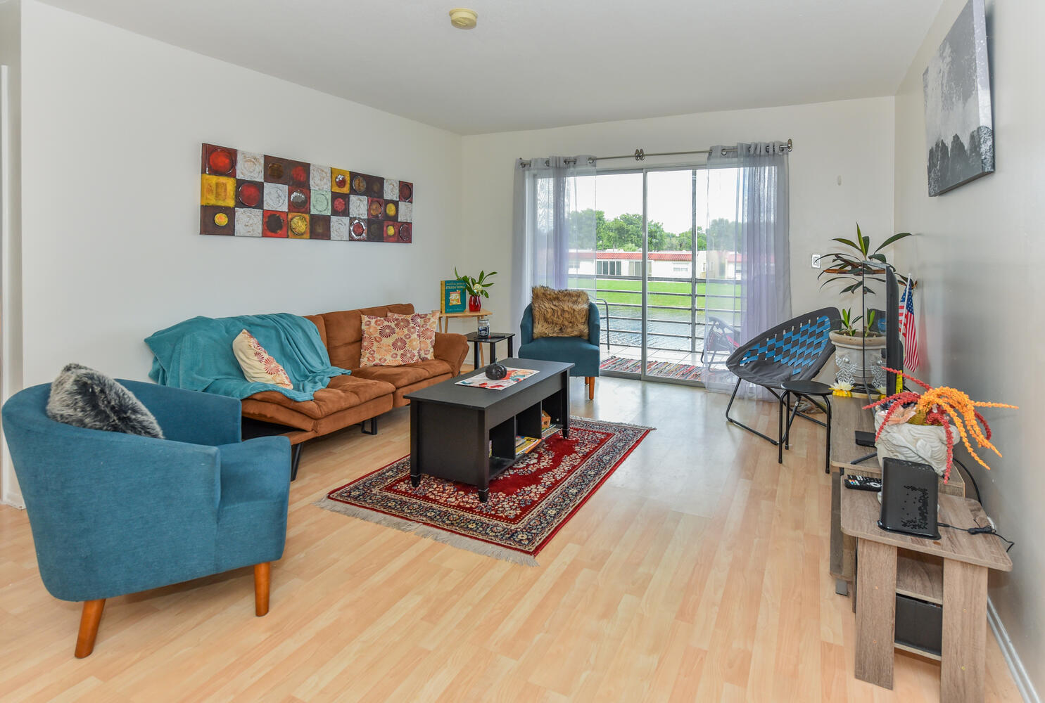 477 Lake Dora Drive West Palm Beach, FL 33411 - Photo 16 of 28 a living room with furniture a flat screen tv and a large window