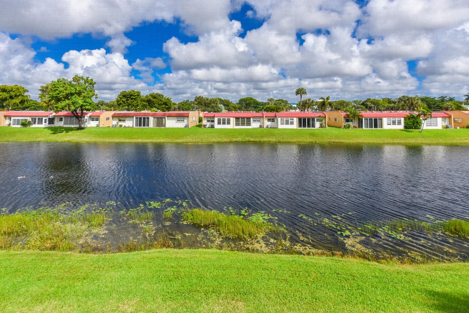 477 Lake Dora Drive West Palm Beach, FL 33411 - Photo 27 of 28 a view of a lake with houses in the background