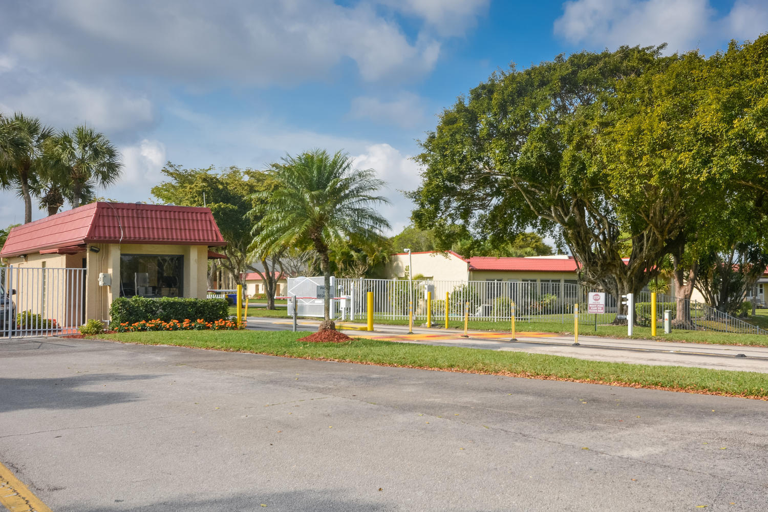 477 Lake Dora Drive West Palm Beach, FL 33411 - Photo 3 of 28 a front view of a building with small garden