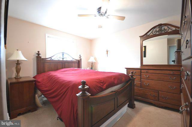 130 Garden Ridge Road Baltimore, MD 21228 - Photo 14 of 16 a spacious bedroom with a bed and a dresser