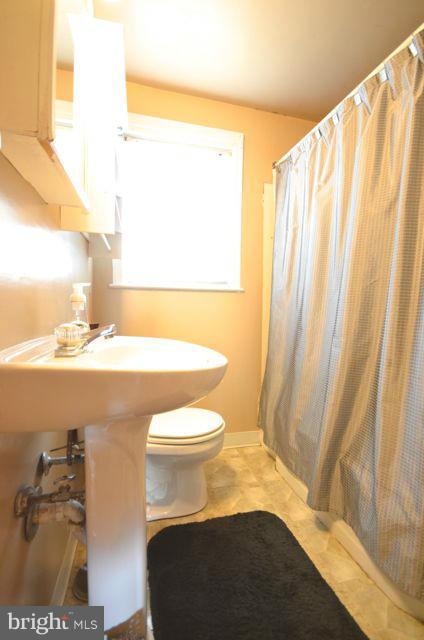 130 Garden Ridge Road Baltimore, MD 21228 - Photo 16 of 16 a bathroom with a sink and a mirror