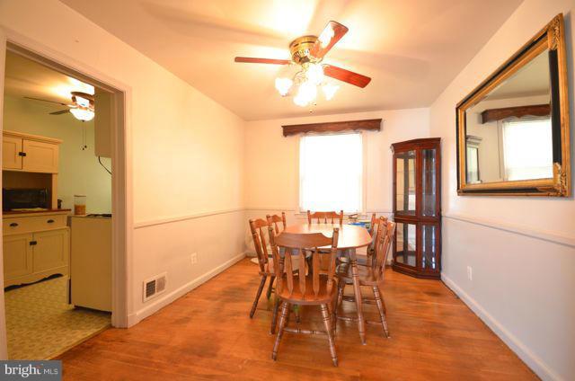 130 Garden Ridge Road Baltimore, MD 21228 - Photo 4 of 16 a view of a dining room with furniture and a chandelier