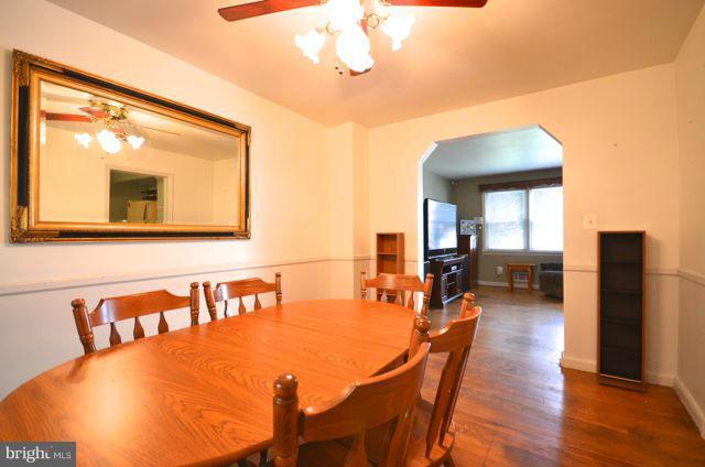 130 Garden Ridge Road Baltimore, MD 21228 - Photo 5 of 16 a view of a dining room with furniture and wooden floor
