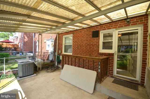 130 Garden Ridge Road Baltimore, MD 21228 - Photo 8 of 16 a view of backyard with barbeque grill and outdoor seating