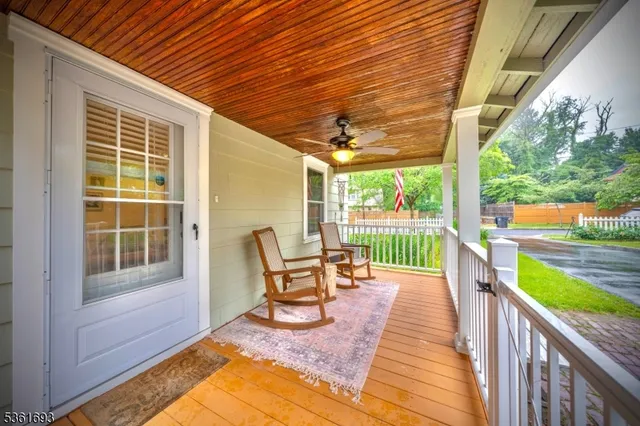 a balcony with chairs and table