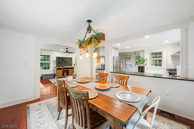 a dining room with furniture a rug and a painting