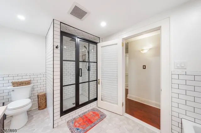 a bathroom with a toilet sink and shower
