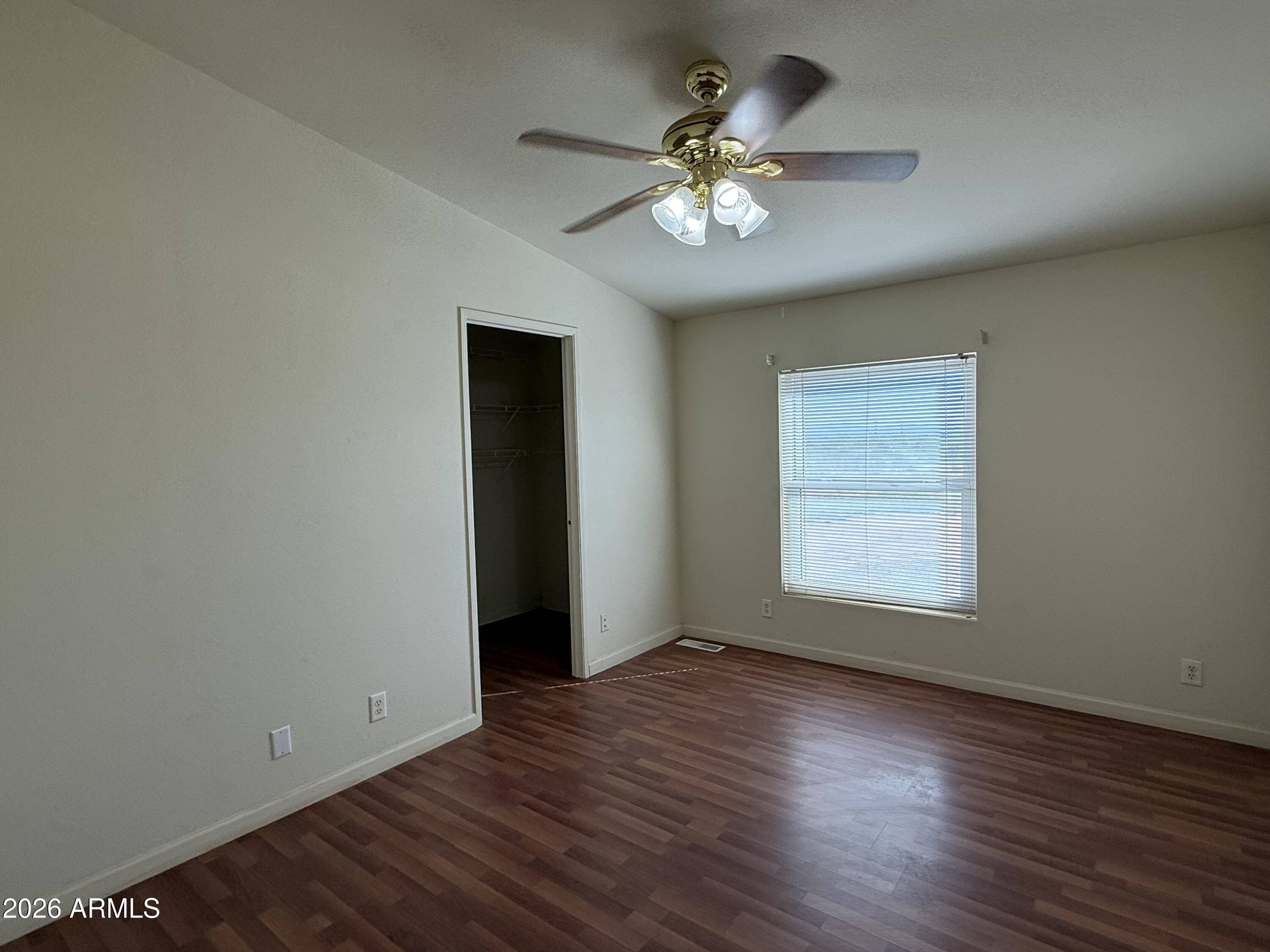 6206 South Ranch Road Hereford, AZ 85615 - Photo 11 of 14 a view of an empty room with wooden floor and a window