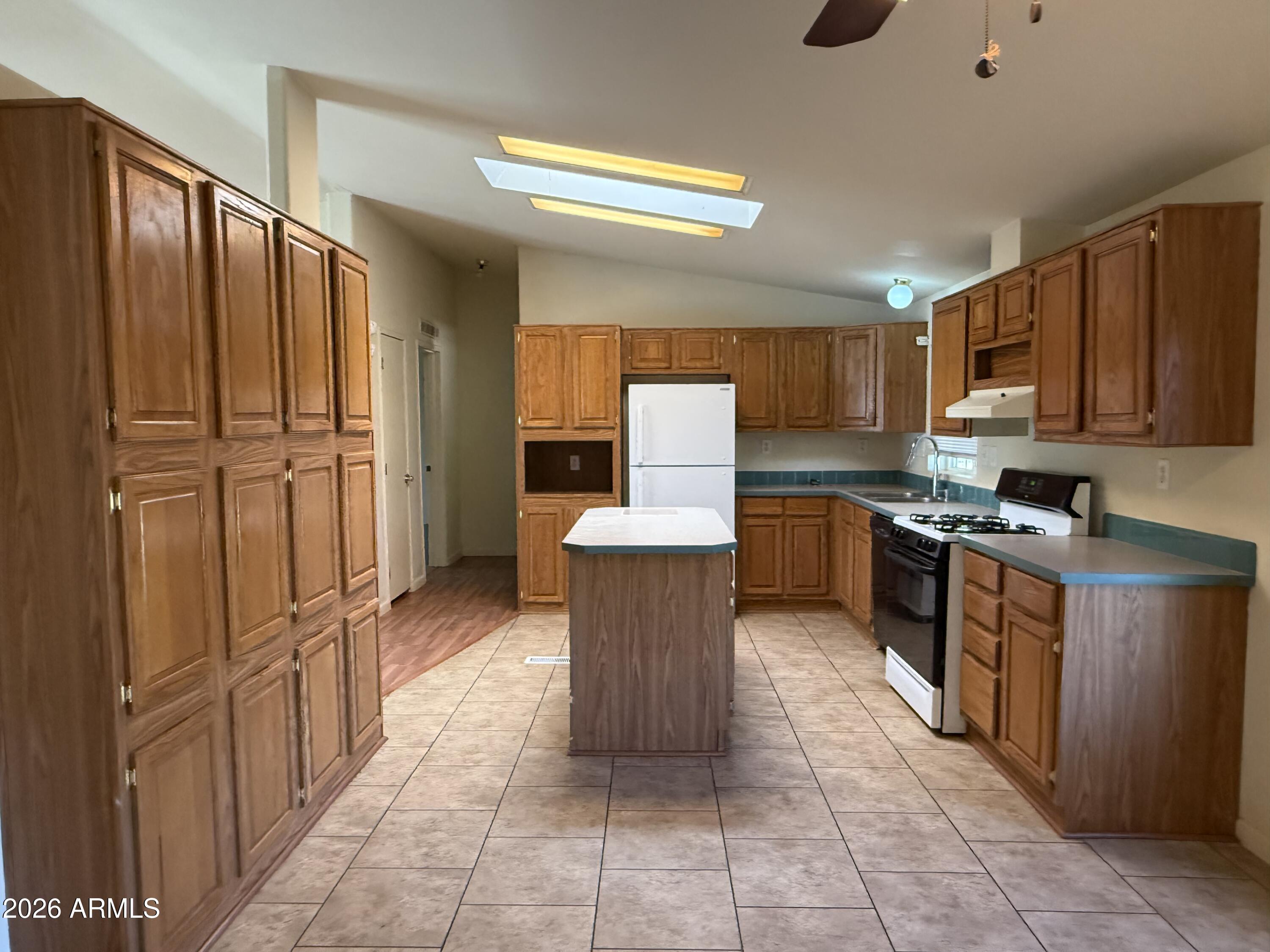 6206 South Ranch Road Hereford, AZ 85615 - Photo 5 of 14 a kitchen with stainless steel appliances granite countertop a refrigerator and a stove top oven