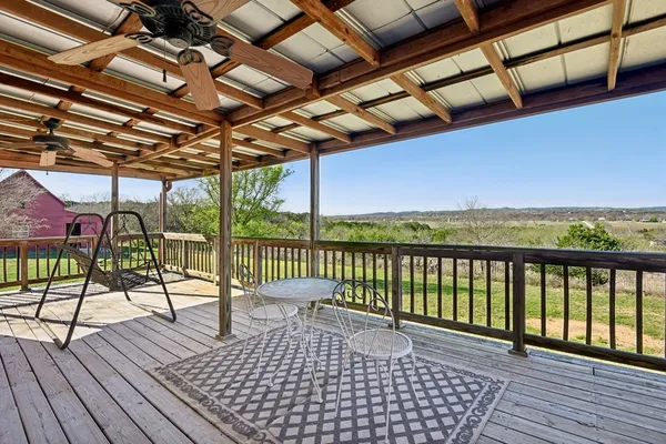 a view of a balcony with wooden floor