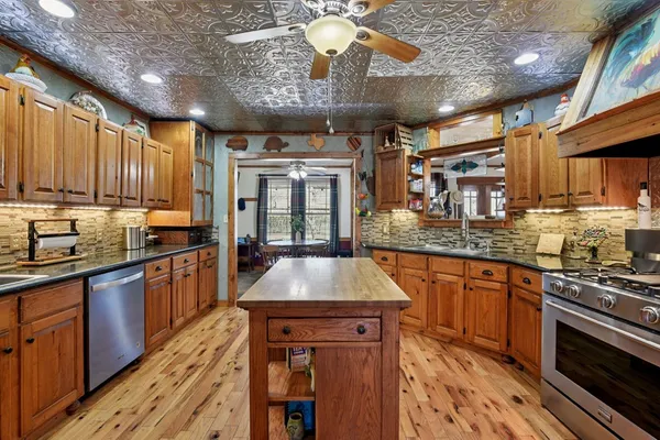 a kitchen with stainless steel appliances granite countertop a sink stove and refrigerator