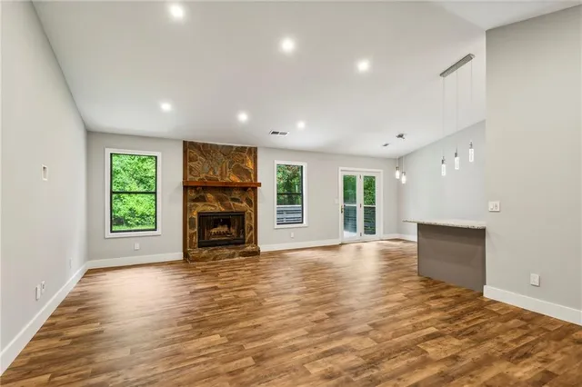 a kitchen with granite countertop a stove a sink and a refrigerator