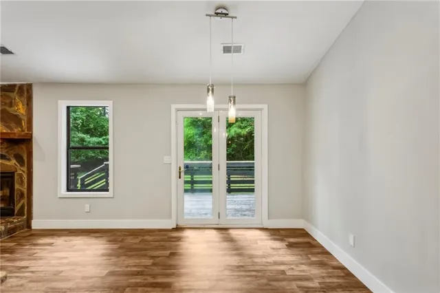 a kitchen with granite countertop a sink cabinets and wooden floor