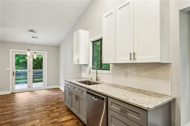 a kitchen with granite countertop a sink and a window