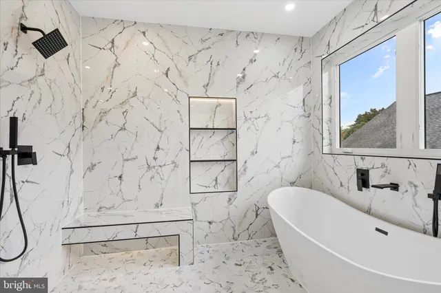 a bathroom with a bathtub and shower