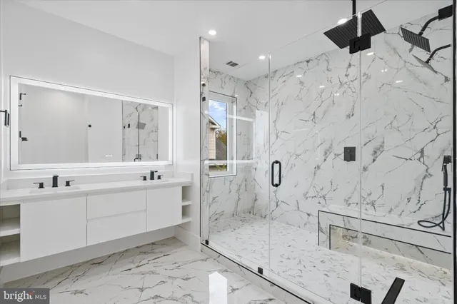 a large bathroom with a granite countertop sink mirror and shower
