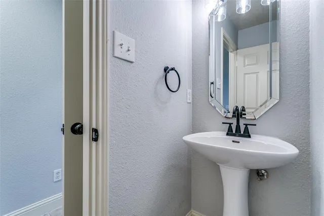 a bathroom with a sink a mirror and shower