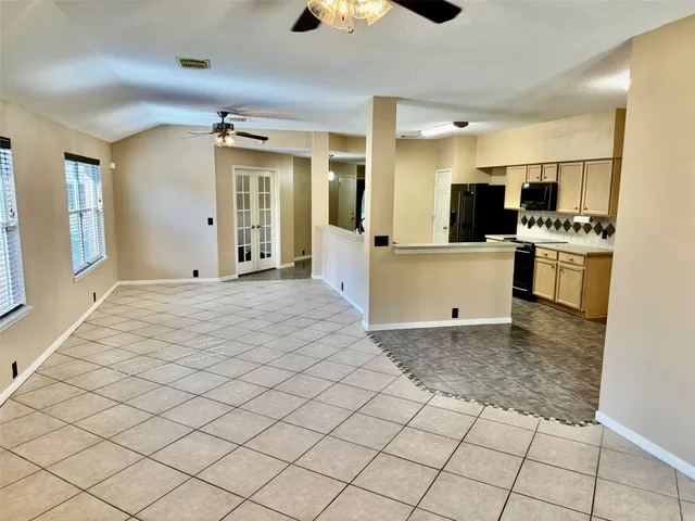a view of a kitchen with kitchen island granite countertop living room