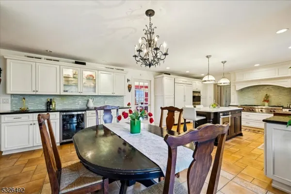 a view of a dining room with furniture and a chandelier
