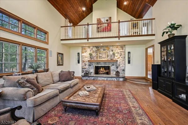a living room with furniture a rug and a fireplace