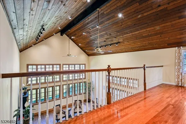 a view of staircase with lots of frames on wall